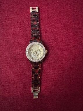 Sophie brand analog/gold-tone bezel set with rhinestones/tortoiseshell-pattern